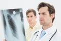 Concentrated doctor and patient examining lungs xray
