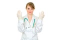 Concentrated doctor woman in latex medical gloves