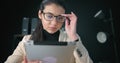 Concentrated female working on electronic device