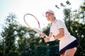 Concentrated on game. beautiful young woman holding tennis racket and looking away Royalty Free Stock Photo