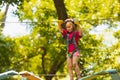 The concentrated girl carefully overcomes obstacles in the rope park Royalty Free Stock Photo