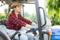 Concentrated girl farmer is sitting at the wheel of a tractor Royalty Free Stock Photo