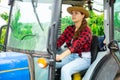 Concentrated girl farmer is sitting at the wheel of a tractor Royalty Free Stock Photo