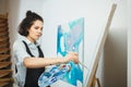 Concentrated girl focused on creative art-making process in art therapy Royalty Free Stock Photo