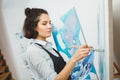 Concentrated girl focused on creative art-making process in art therapy Royalty Free Stock Photo