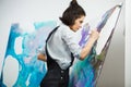 Concentrated girl focused on creative art-making process in art therapy Royalty Free Stock Photo