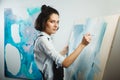 Concentrated girl focused on creative art-making process in art therapy Royalty Free Stock Photo