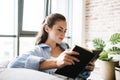 Concentrated girl reading book