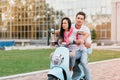 Concentrated girl with shiny black hair learning to drive in summer day. Extreme brunette lady wears trendy ripped pants Royalty Free Stock Photo