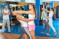 Girl using painful technique for eyes of female opponent during self-defense training