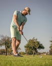 concentrated golfer in cap with golf club, golfing