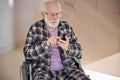 Concentrated gray-headed man texting on his smartphone Royalty Free Stock Photo