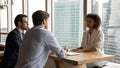 Focused male employers interviewing african american candidate. Royalty Free Stock Photo