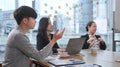 Concentrated group of diverse business partners listening intently during discussion of development strategy at meeting Royalty Free Stock Photo