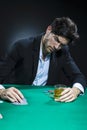 Concentrated Handsome Caucasian Brunet  Pocker Player At Pocker Table With Chips While Drinking Alcohol While Playing Royalty Free Stock Photo