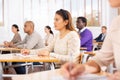 Concentrated hispanic girl at lecture during adult education class Royalty Free Stock Photo