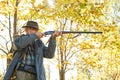 Senior hunter with his rifle in autumn forest Royalty Free Stock Photo