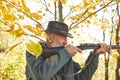 Senior hunter with his rifle in autumn forest Royalty Free Stock Photo