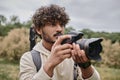 concentrated indian photographer using professional camera