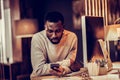 Concentrated international bearded man reading income message Royalty Free Stock Photo