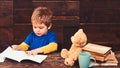 Concentrated kid writing in copybook. Preschool boy sitting at desk. Learning letters in kindergarten Royalty Free Stock Photo