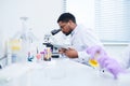 Concentrated lab technician using microscope Royalty Free Stock Photo