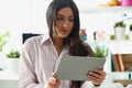 Concentrated lady look in tablet screen, work from home, remotely solve working task