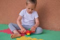 concentrated little girl playing building blocks lego colorful constructor bricks toys