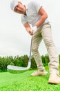 Concentrated male golfer with a golf club