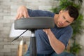 concentrated man assembling adjustable stool Royalty Free Stock Photo