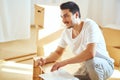 Concentrated man reading instructions to assemble furniture at home Royalty Free Stock Photo