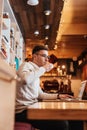 Concentrated man sitting in cafe and using laptop Royalty Free Stock Photo