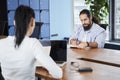 Concentrated man is sitting at desk Royalty Free Stock Photo