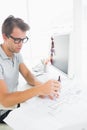 Concentrated man using compass on design Royalty Free Stock Photo