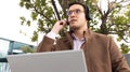 concentrated man working with laptop and microphone in a park Royalty Free Stock Photo