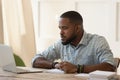 Concentrated millennial african american guy focused on online university courses. Royalty Free Stock Photo