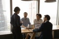 Concentrated mixed race people listening to team leader. Royalty Free Stock Photo