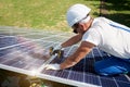 Concentrated mounter installing innovative solar panels. Royalty Free Stock Photo