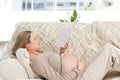 Concentrated pregnant woman reading a book