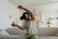 Concentrated satisfied black boy plays video game racing drives car in virtual reality goggles.