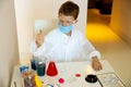 Concentrated schoolboy doing experiment during quarantine time Royalty Free Stock Photo