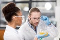 Concentrated scientists analyzing test tube in laboratory