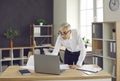 Concentrated senior European businessman while working with laptop computer in office.