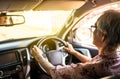 Concentrated senior woman driver hold steering wheel steady using slow speed to avoid accidents,asian elderly people driving