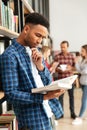 Concentrated serious african man reading book Royalty Free Stock Photo