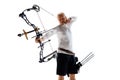 Concentrated serious man aiming with archery bow on target, training isolated over white studio background. Archery Royalty Free Stock Photo