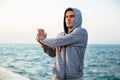 Concentrated sportsman doing exercise for arm, outdoors