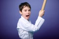 Strong schoolboy - aikido fighter holds bamboo katana weapon and practices martial skills, isolated on purple background with copy