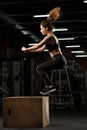 Concentrated strong sports lady make sport exercises jumping Royalty Free Stock Photo