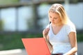 Concentrated student e-learning using a laptop outdoors Royalty Free Stock Photo